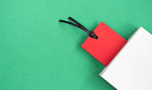 Graphic of red bookmark in new white paperback on green background